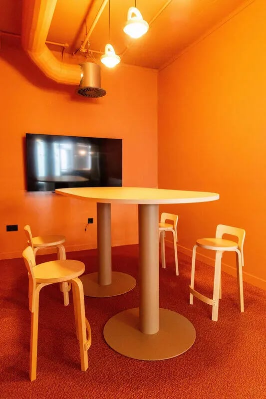 Round table with chairs near television living room at Martha Street Apartments in Glasgow Student Accommodation