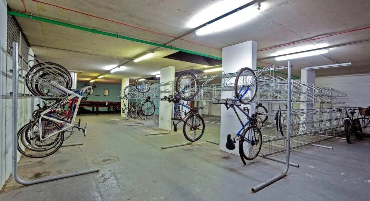 Bikes on racks underground storage Bicycle storage area at Griffon Studios in London Student Accommodation