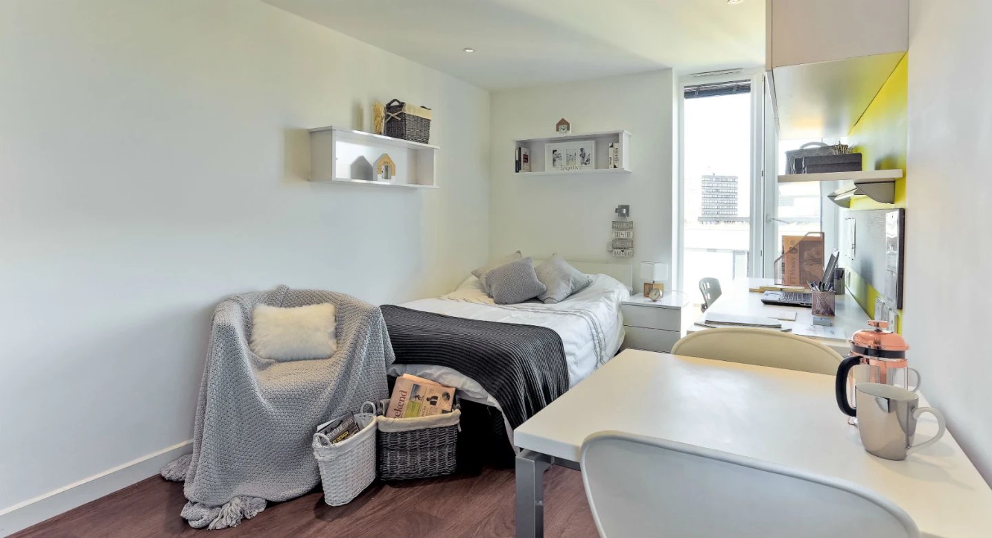 Bed chair desk with laptop and French press bedroom at Griffon Studios in London Student Accommodation