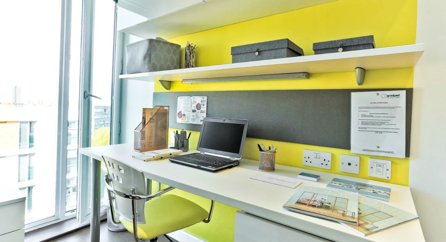 Desk with laptop, chair, and storage study area at Griffon Studios in London Student Accommodation