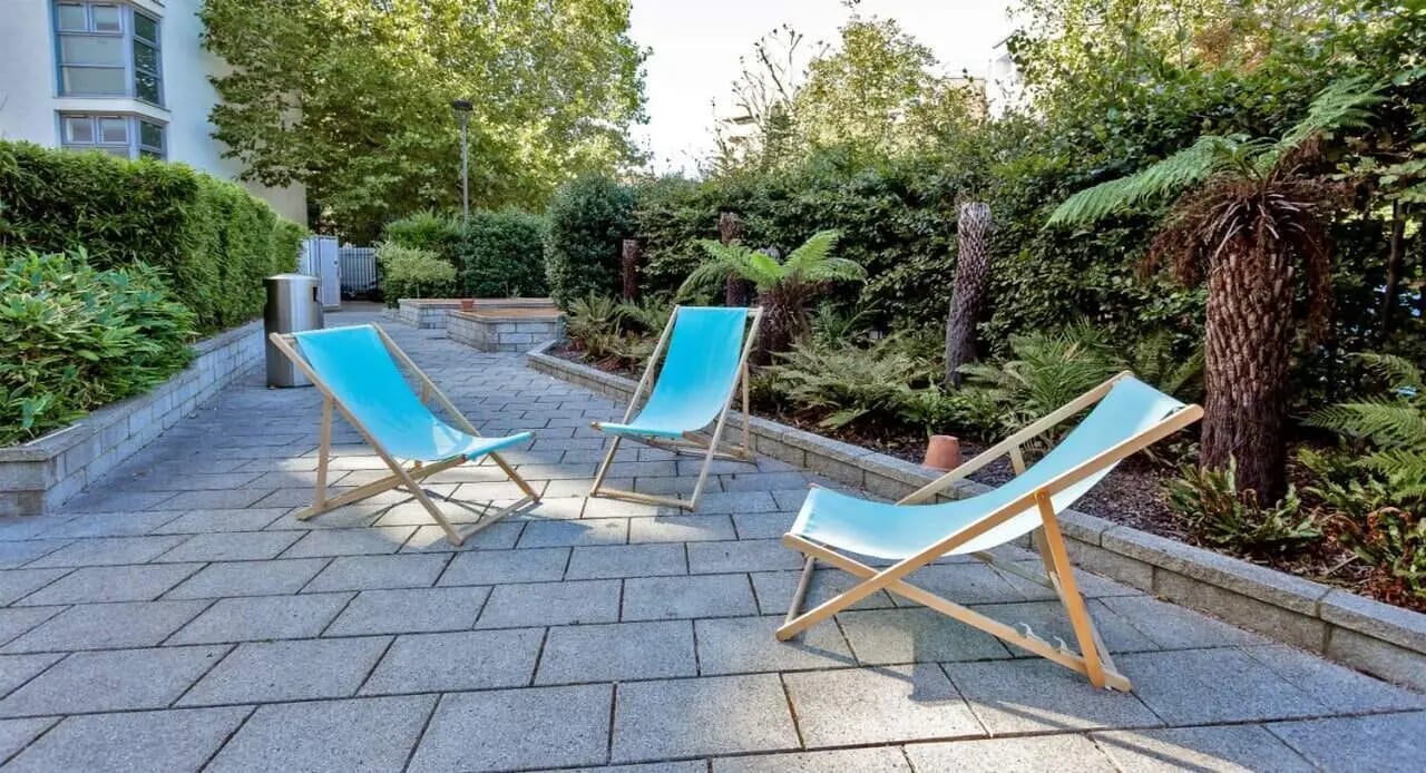 Blue deck chairs on patio outdoor area exterior at Griffon Studios in London Student Accommodation