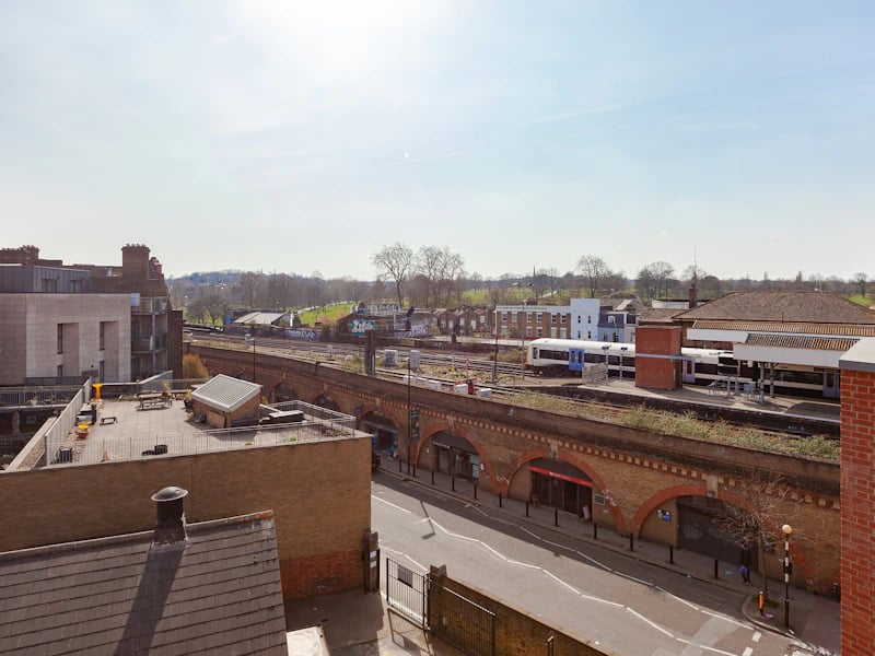 Rooftop seating area train tracks and buildings exterior at Academic House in London Student Accommodation