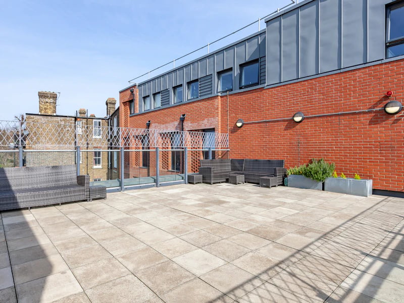 Wicker furniture planters and building exterior exterior at Academic House in London Student Accommodation