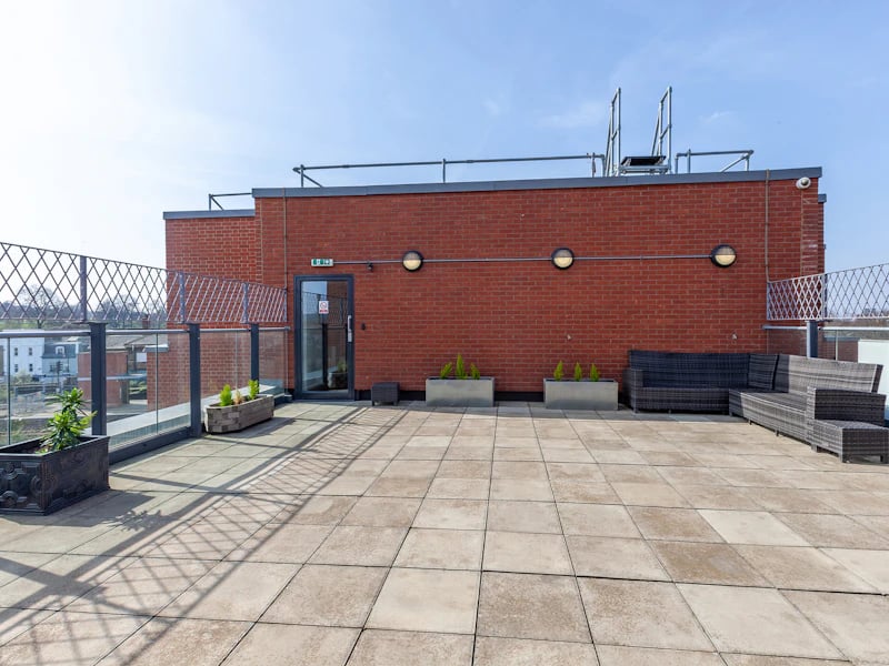 Rooftop patio with furniture plants exterior at Academic House in London Student Accommodation