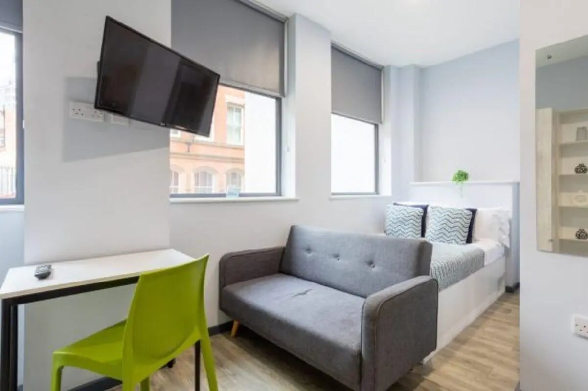 Bed sofa desk TV and chair student room at dwell Archer House in Nottingham Student Accommodation