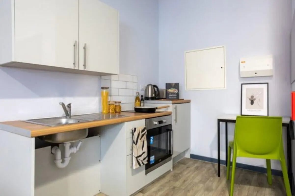Sink oven kettle and chair kitchen at dwell Archer House in Nottingham Student Accommodation