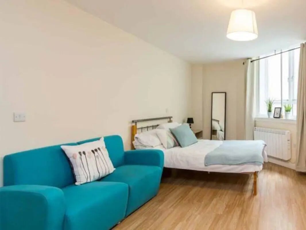 Turquoise sofa bed with mirror bedroom at dwell Castle Gate Haus in Nottingham Student Accommodation