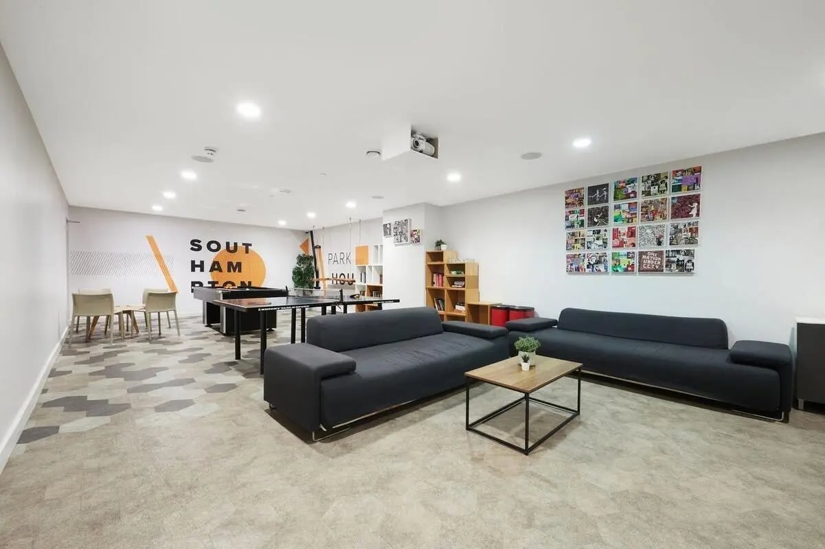 Two sofas ping pong table and seating living room at Collegiate Park House in Southampton Student Accommodation