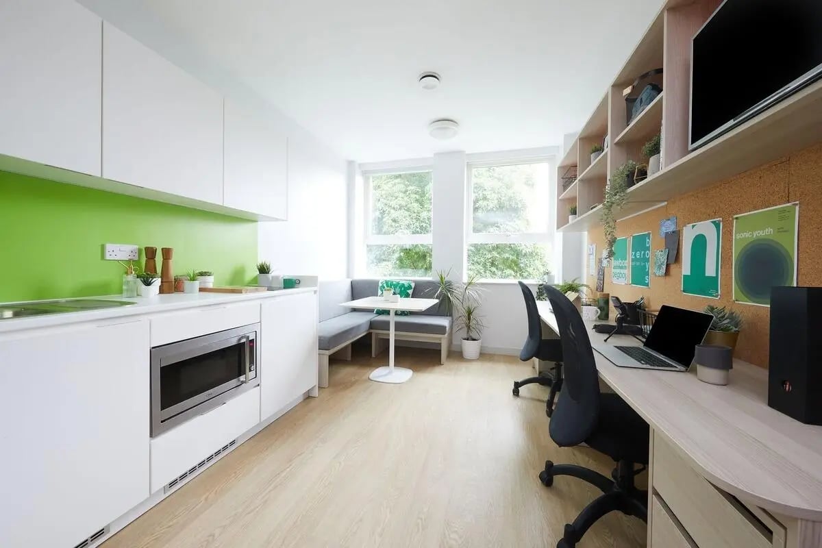 Kitchen study area with built-in seating and desks Living room at Collegiate Park House in Southampton Student Accommodation