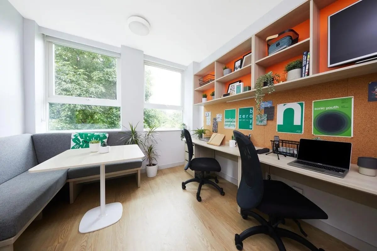 Desk study area with laptops and seating study area at Collegiate Park House in Southampton Student Accommodation