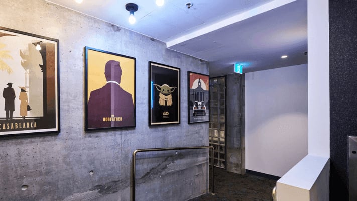 Movie posters on concrete wall corridor at UniLodge Melbourne Flagstaff in Melbourne Student Accommodation