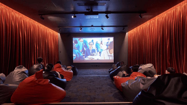 Beanbag seating in a cinema room with red curtains Cinema room at UniLodge Melbourne Flagstaff in Melbourne Student Accommodation