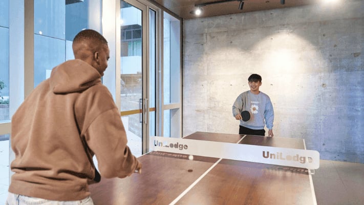 Students playing table tennis at a uni lodge facility. at UniLodge Melbourne Flagstaff in Melbourne Student Accommodation