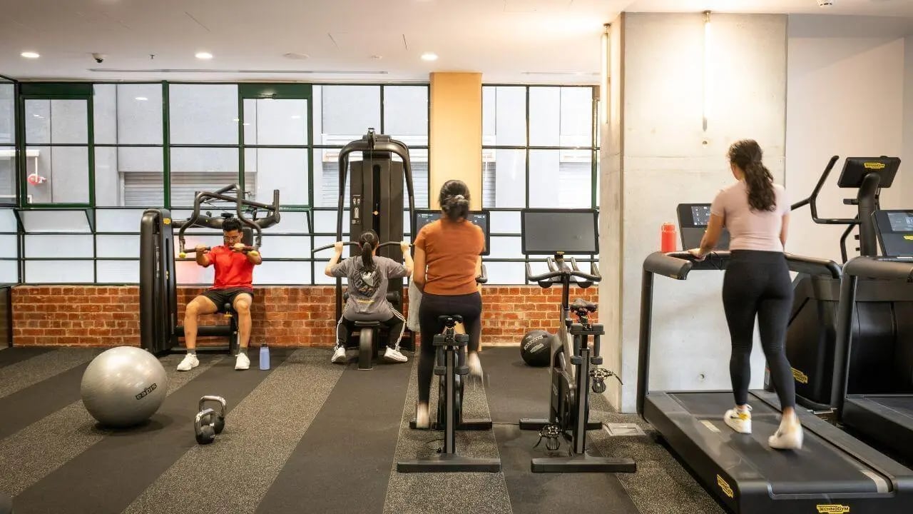 People exercising on gym equipment fitness area at UniLodge Melbourne Flagstaff in Melbourne Student Accommodation