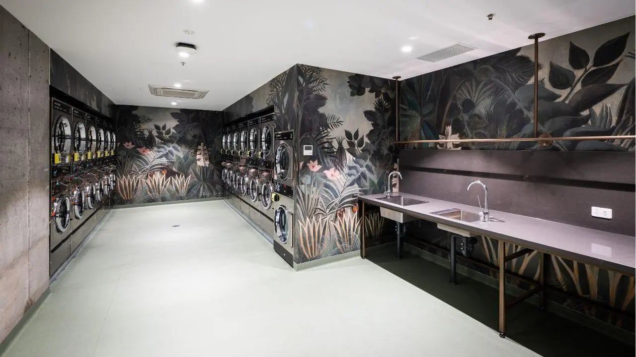 Multiple washing machines and sinks laundry area at UniLodge Melbourne Flagstaff in Melbourne Student Accommodation