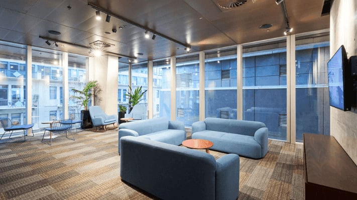 Blue sofas round tables and chairs living room at UniLodge Melbourne Flagstaff in Melbourne Student Accommodation