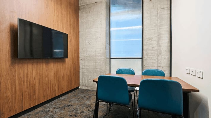 Table chairs television wooden wall meeting room at UniLodge Melbourne Flagstaff in Melbourne Student Accommodation