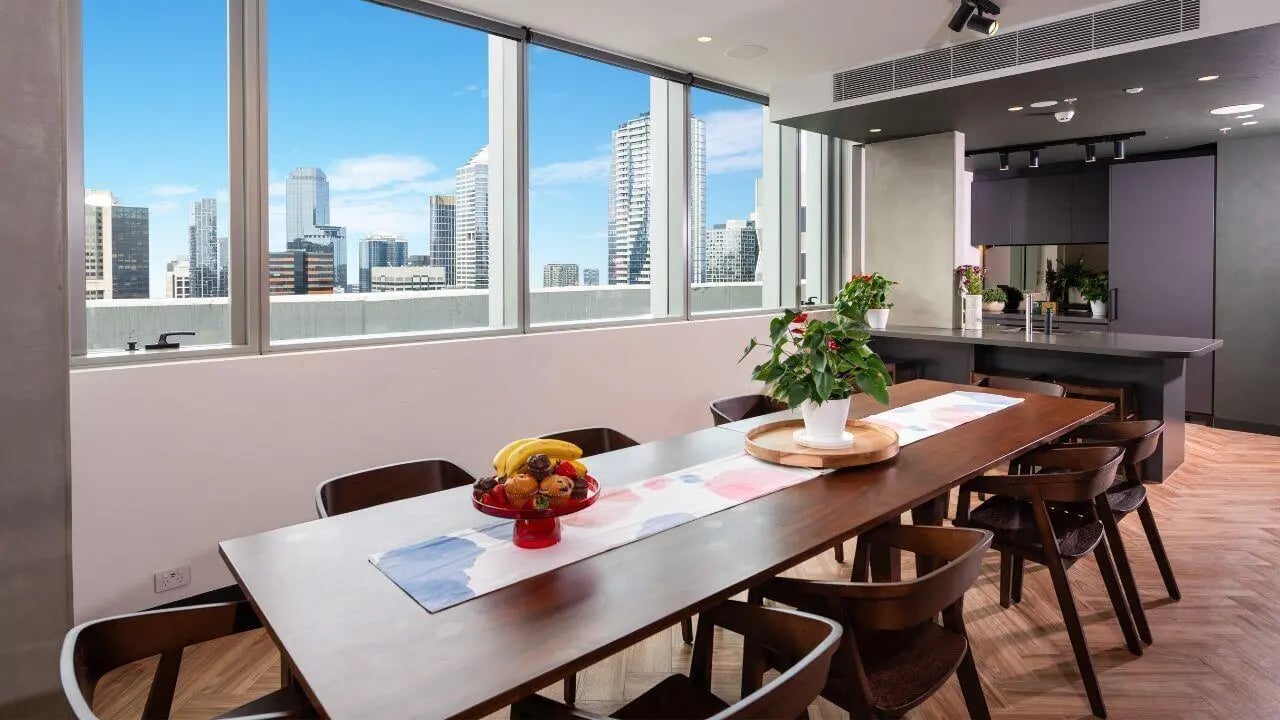 Dining table with fruit and chairs kitchen view at UniLodge Melbourne Flagstaff in Melbourne Student Accommodation