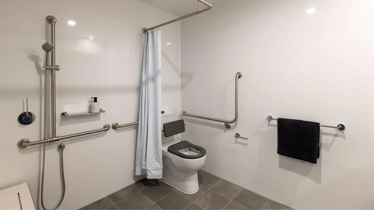 Accessible toilet shower grab bars soap dispenser bathroom at UniLodge Melbourne Central in Melbourne Student Accommodation