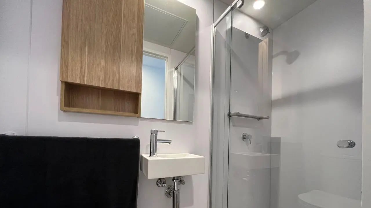 Sink mirror shower and towel bathroom at UniLodge Melbourne Central in Melbourne Student Accommodation