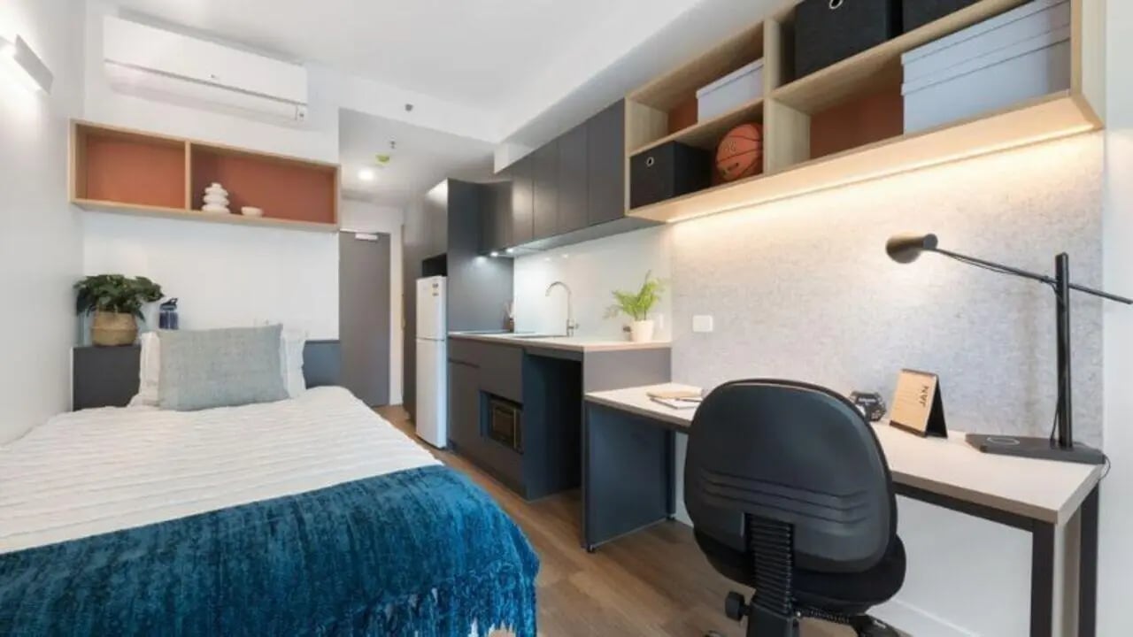 Bed desk kitchen and shelves studio apartment at UniLodge Melbourne Central in Melbourne Student Accommodation