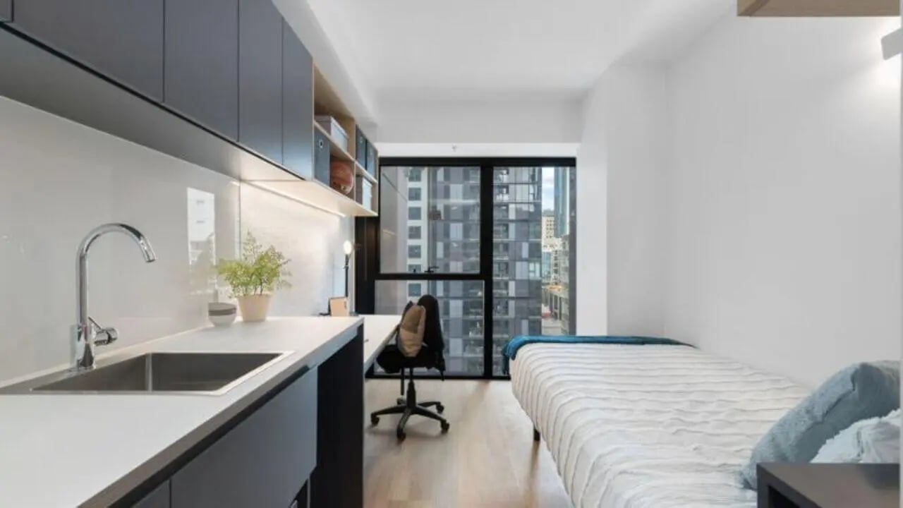 Sink desk bed and window view student accommodation at UniLodge Melbourne Central in Melbourne Student Accommodation