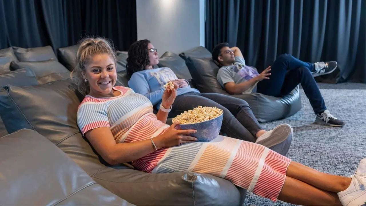 Students relaxing on beanbags with popcorn cinema area at UniLodge Melbourne Central in Melbourne Student Accommodation