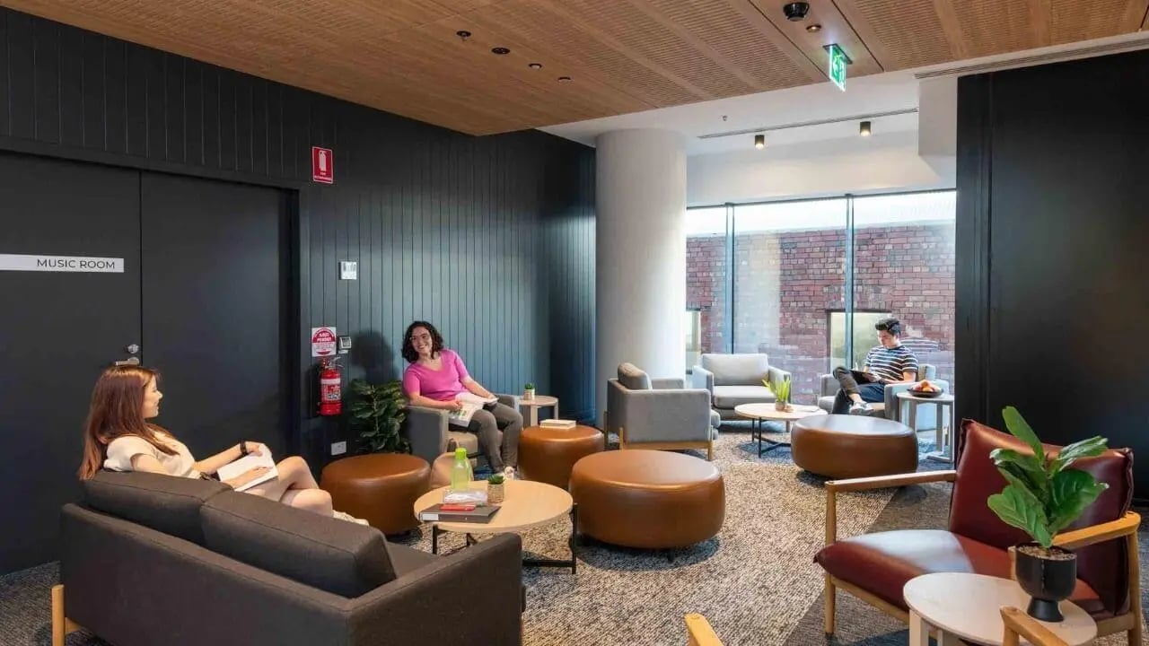 Students relaxing in lounge area with seating living room at UniLodge Melbourne Central in Melbourne Student Accommodation