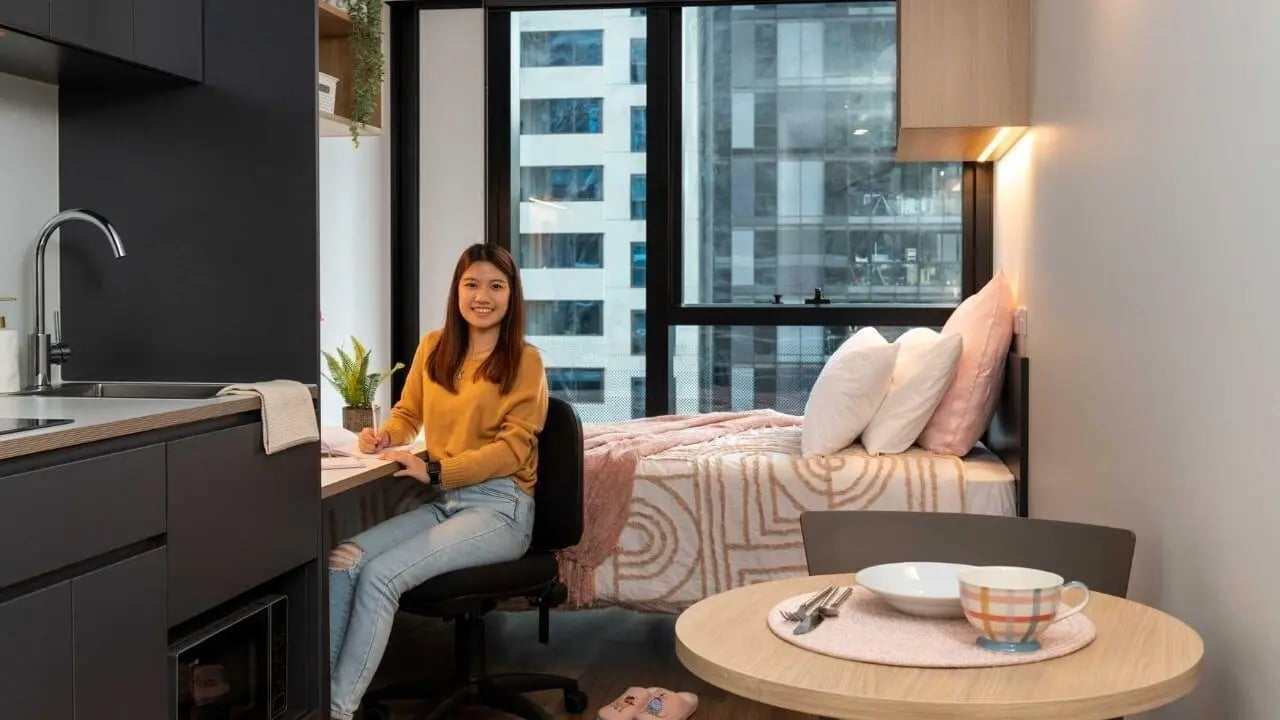 Student desk bed kitchen dining area bedroom at UniLodge Melbourne Central in Melbourne Student Accommodation