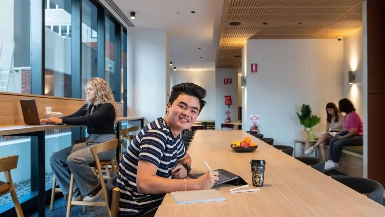 Students working and relaxing communal study area at UniLodge Melbourne Central in Melbourne Student Accommodation