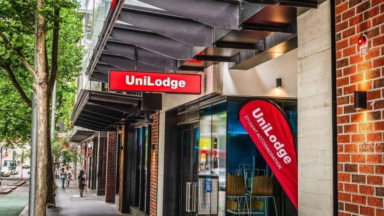 UniLodge sign red banner chairs exterior at UniLodge Melbourne Central in Melbourne Student Accommodation