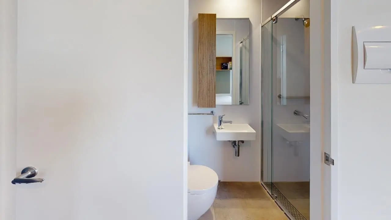 White sink toilet shower with glass door bathroom at Unilodge Melbourne City in Melbourne Student Accommodation