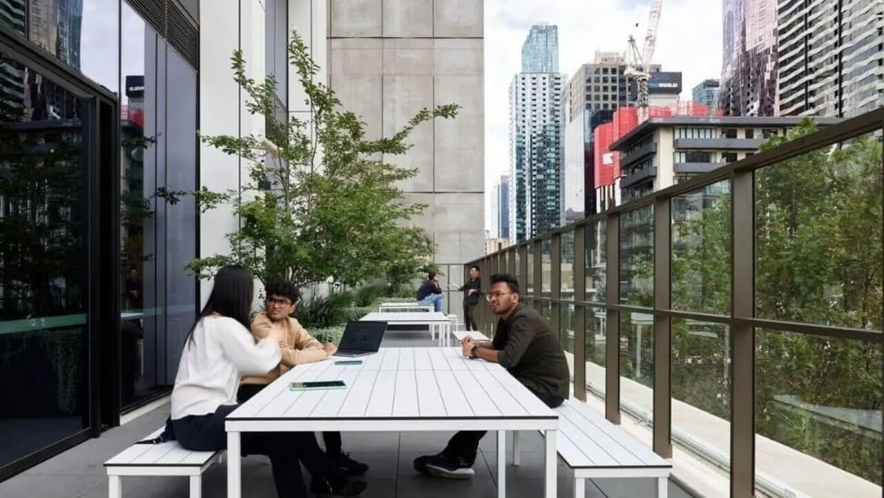 Students study at tables with laptops outdoor area at Unilodge Melbourne City in Melbourne Student Accommodation