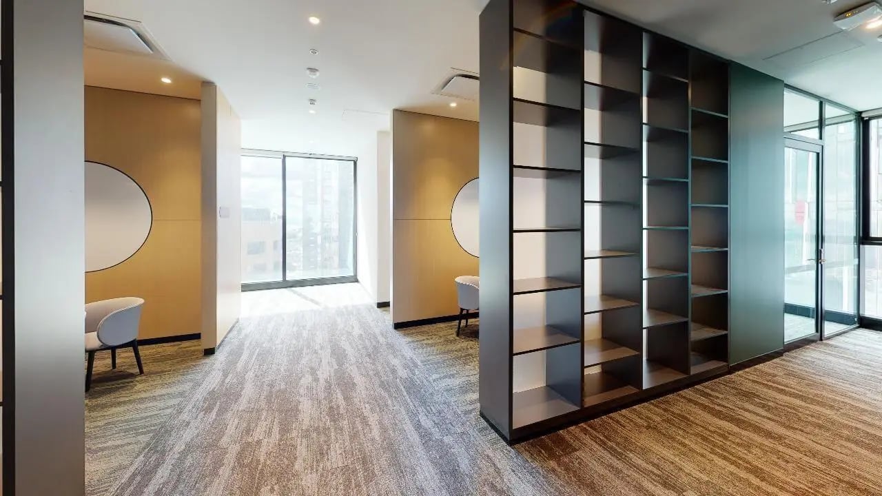 Bookshelves chairs window lounge area at Unilodge Melbourne City in Melbourne Student Accommodation