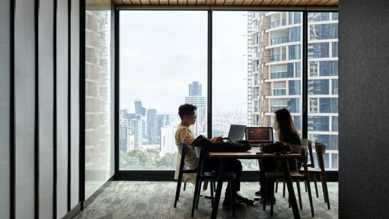 Students working on laptops at desk study area at Unilodge Melbourne City in Melbourne Student Accommodation