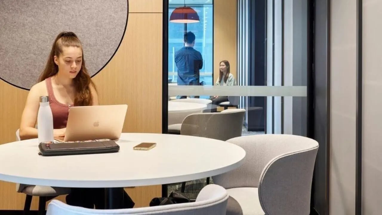 Student working at laptop communal seating area at Unilodge Melbourne City in Melbourne Student Accommodation