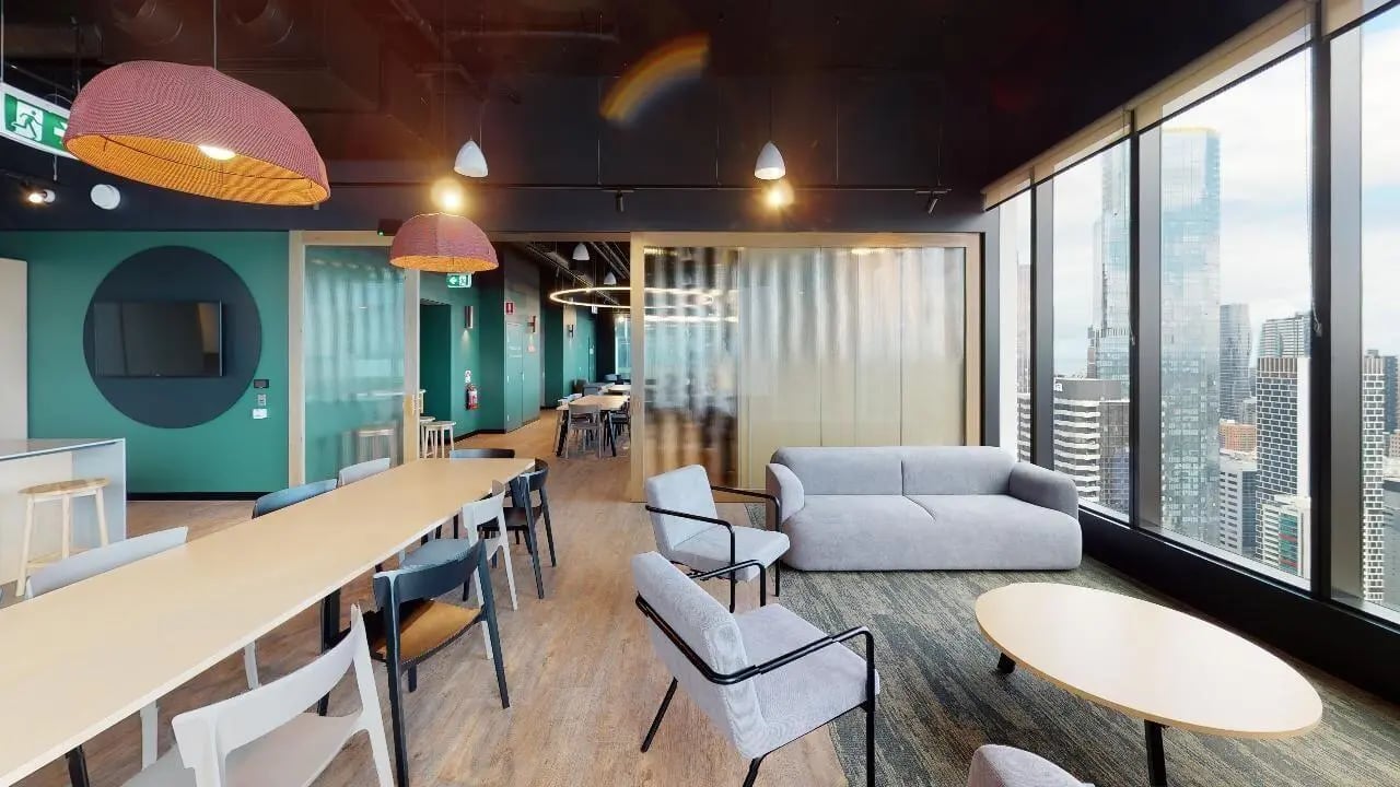 Lounge with sofa tables chairs and city view lounge at Unilodge Melbourne City in Melbourne Student Accommodation
