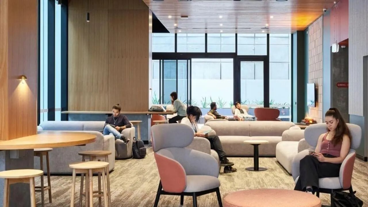 Students relaxing in a modern communal lounge area at Unilodge Melbourne City in Melbourne Student Accommodation