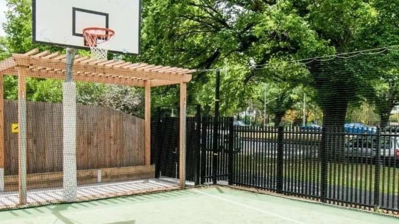 Basketball hoop wooden pergola fence outdoor court playing area at UniLodge Park Avenue in Melbourne Student Accommodation