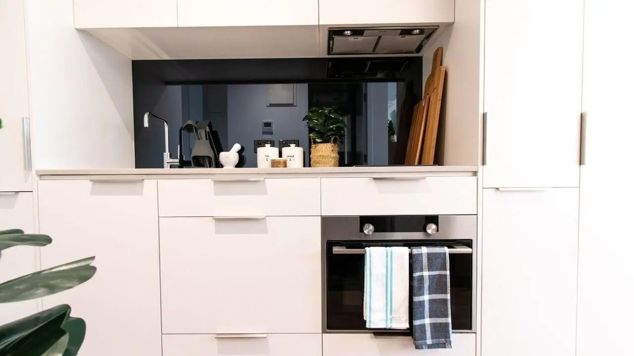 Modern white kitchen with oven and chopping boards Kitchen at UniLodge Park Avenue in Melbourne Student Accommodation