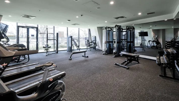 Treadmills weight machines benches gym equipment fitness area at UniLodge Park Avenue in Melbourne Student Accommodation