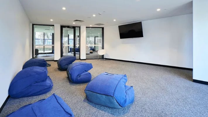 Blue beanbags on carpet with TV living area at UniLodge Park Avenue in Melbourne Student Accommodation