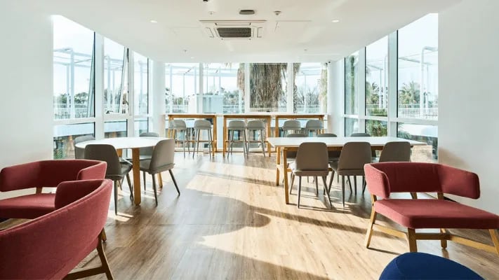 Red chairs tables and bar stools communal area at UniLodge Park Avenue in Melbourne Student Accommodation