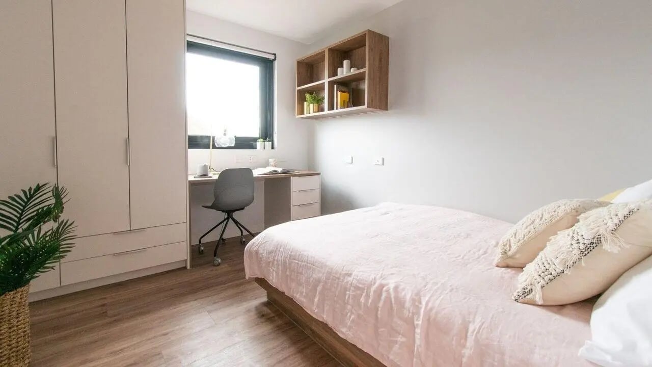 Bed desk chair wardrobe with plant Bedroom at UniLodge Park Avenue in Melbourne Student Accommodation