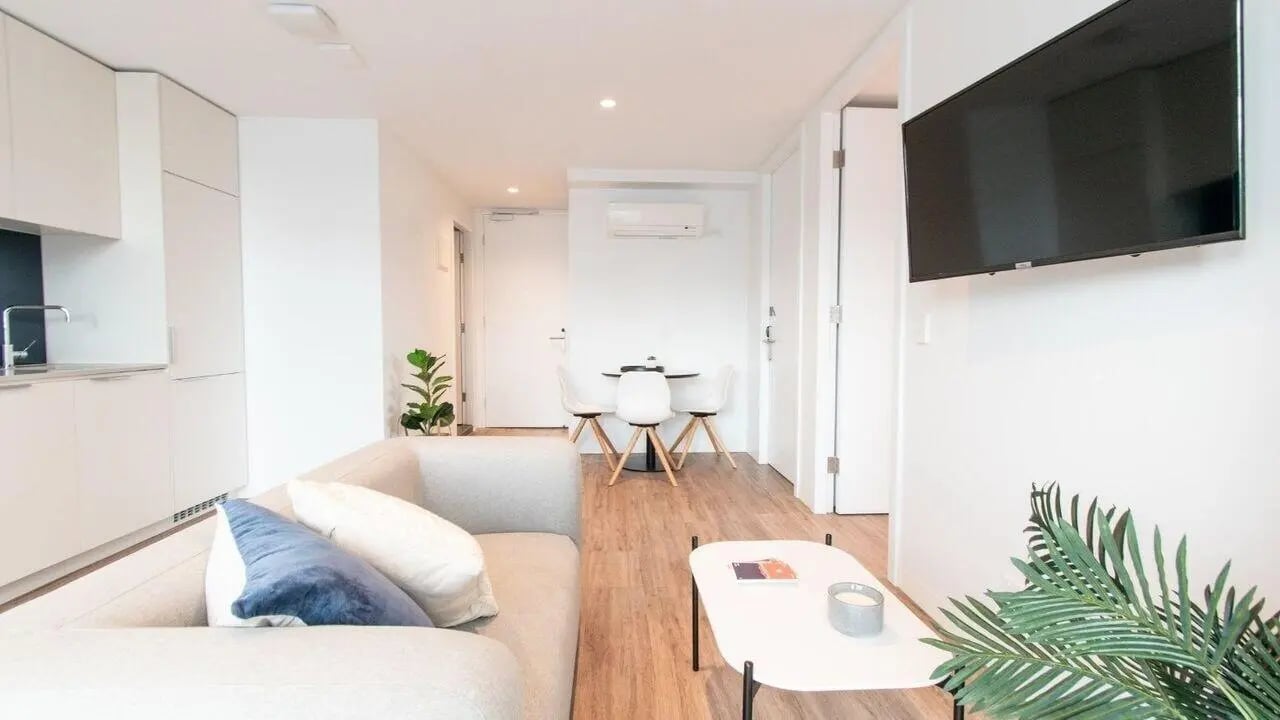 Sofa dining table kitchen and television living room at UniLodge Park Avenue in Melbourne Student Accommodation