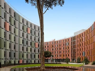 Curved student buildings with colorful facade exterior at La Trobe University - North and South Apartments in Melbourne Student Accommodation