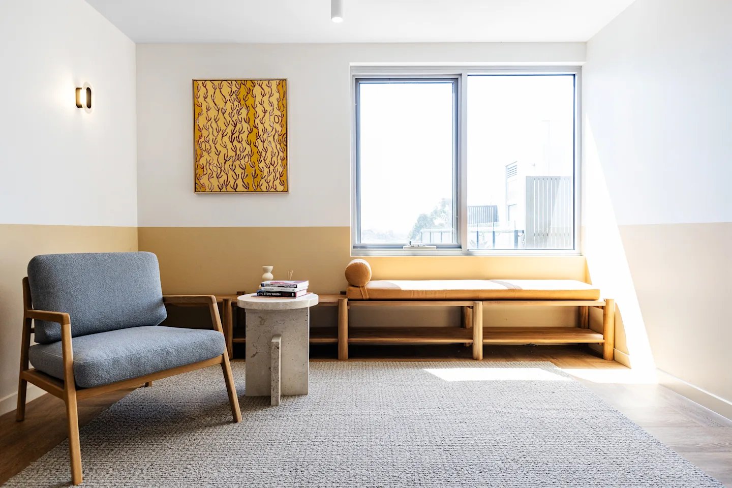 Grey armchair and bench near window living room at UKO Royal Park in Melbourne Student Accommodation