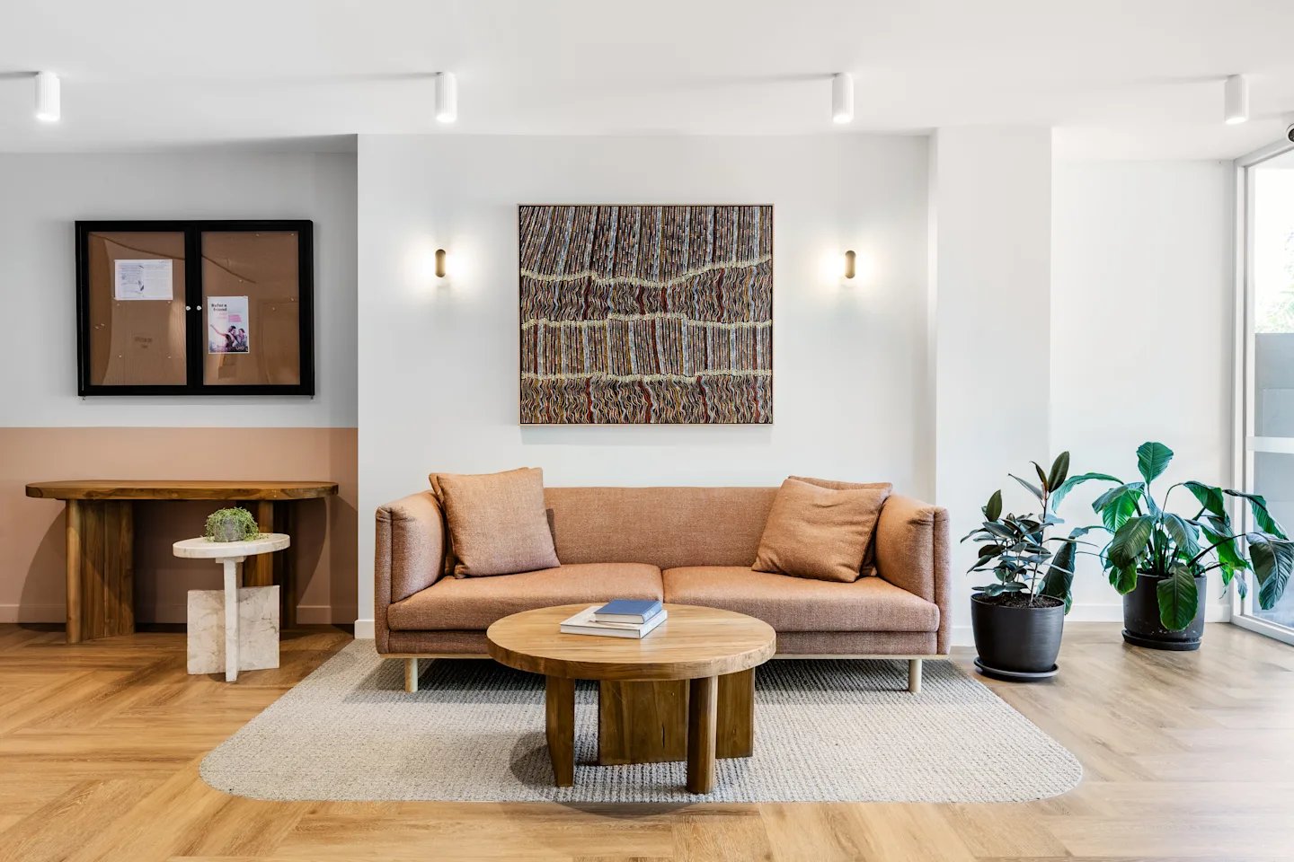 Sofa table rug artwork plants living room at UKO Royal Park in Melbourne Student Accommodation