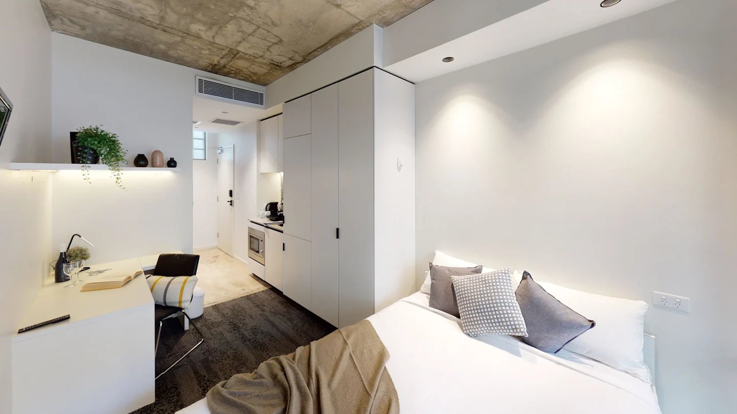 Bed desk kitchen microwave storage and wardrobe studio at UKO Surry Hills in Sydney Student Accommodation