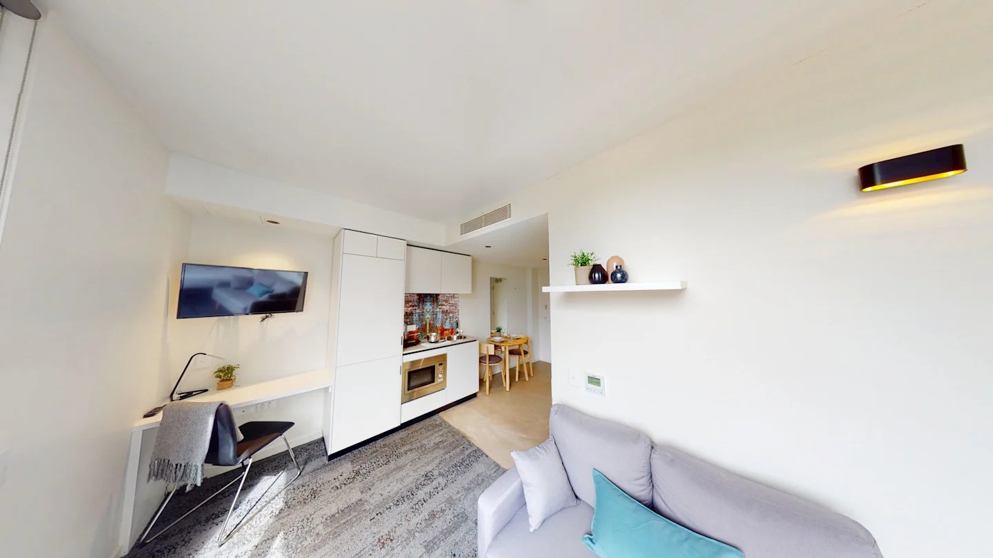 Sofa desk kitchen dining area studio apartment at UKO Surry Hills in Sydney Student Accommodation